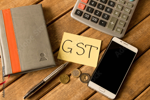 Good service and tax . Calculator, Notepad, pen, coins, smartphone on wooden background