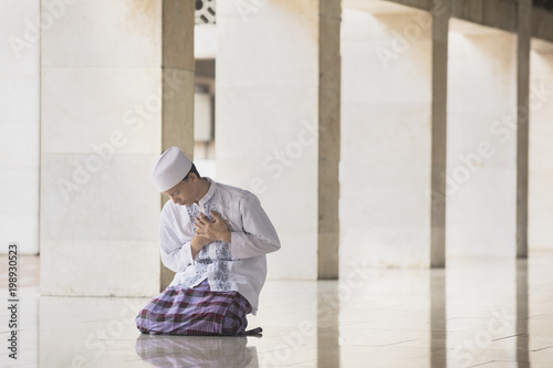 Devout Muslim man looks sad in the mosque