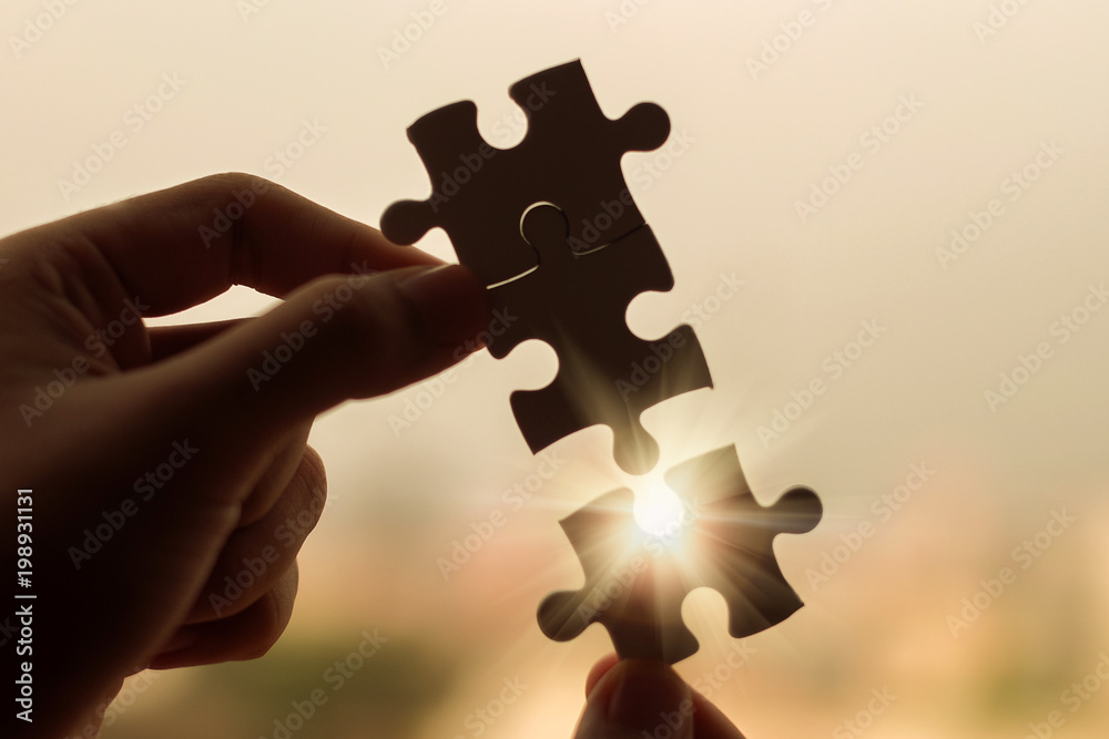 Silhouette Woman hands connecting couple puzzle piece against sunrise effect, businesswoman holding jigsaw with sunset background. Business solutions, target, success, goals and strategy concepts - obrazy, fototapety, plakaty 