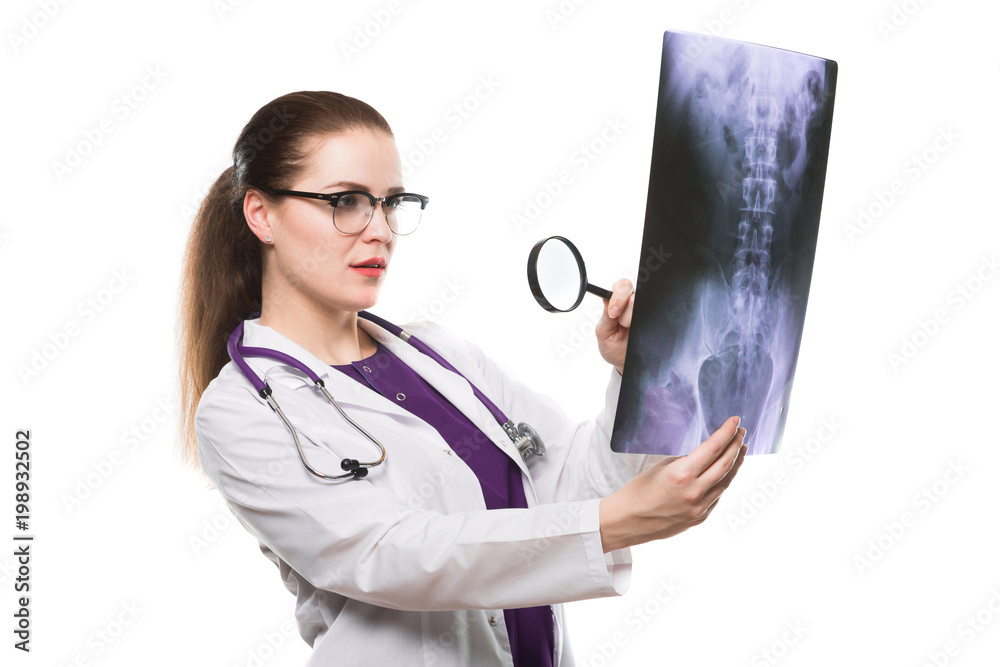 Attractive young woman doctor looking at x-ray making diagnosis in white uniform on white background Attractive young woman doctor looking at x-ray making diagnosis in white uniform on white background