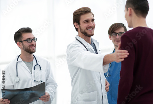 handsome doctor talking with the patient