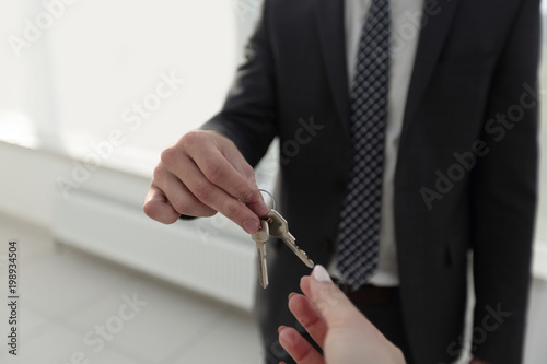 Estate Agent Giving House Keys To Person