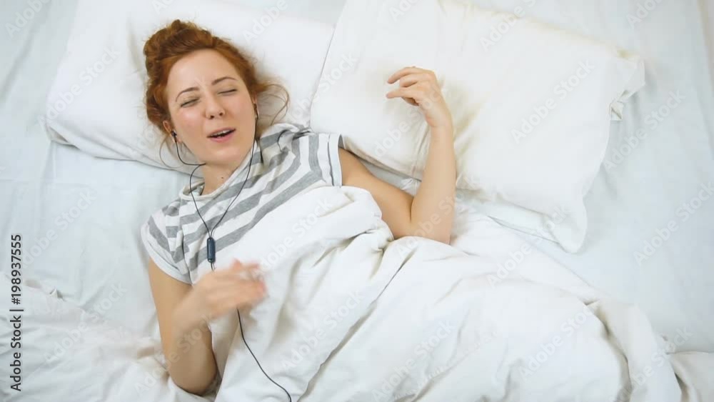 Attractive young foxy woman playing imaginary guitar while sleeping Attractive young foxy woman playing imaginary guitar while sleeping
