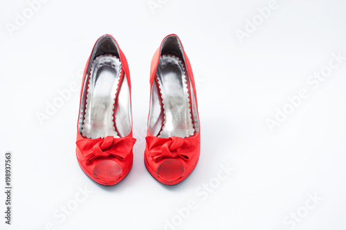 red female shoes with a bow on a white background 