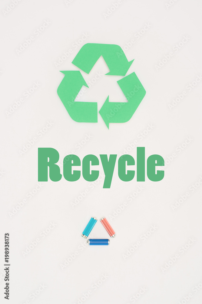 top view of batteries with recycle sign on white top view of batteries with recycle sign on white