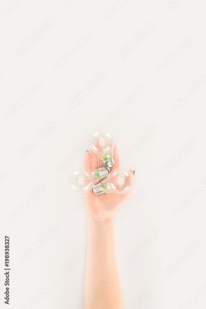 cropped shot of woman holding light bulbs isolated on white cropped shot of woman holding light bulbs isolated on white