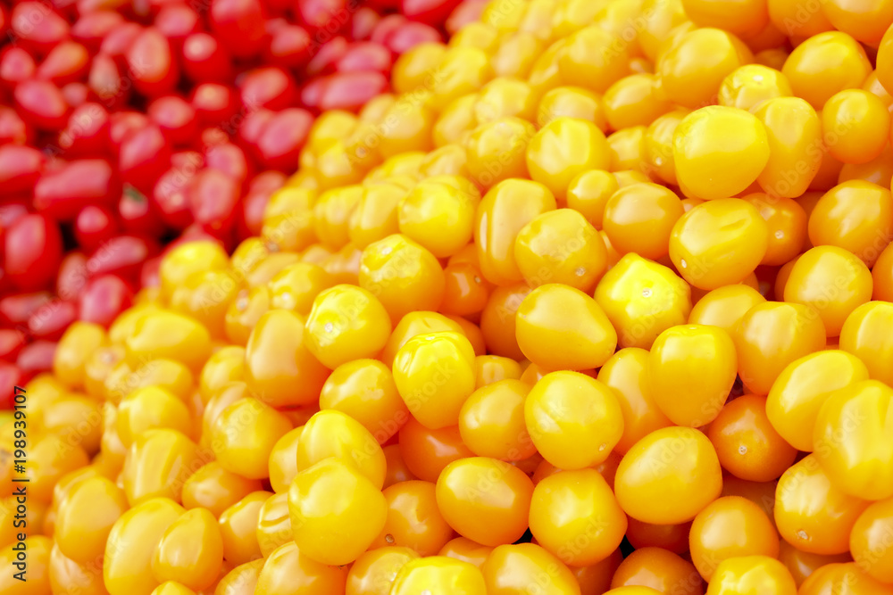 Clean eating concept. Bunch of ripe juicy fresh organic yellow red cherry mixed tomatoes pile at local produce farmers market. Healthy diet, spring summer detox. Vegan raw food. Close up, background. Clean eating concept. Bunch of ripe juicy fresh organic yellow red cherry mixed tomatoes pile at local produce farmers market. Healthy diet, spring summer detox. Vegan raw food. Close up, background.