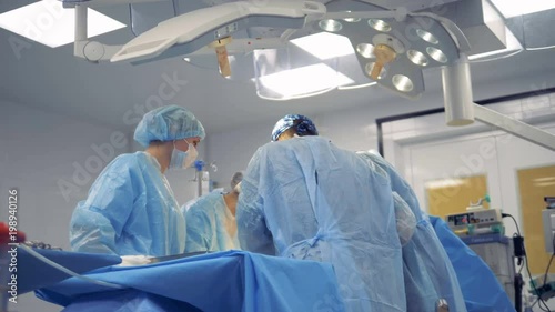 Medical Team Performing Surgical Operation in Modern Operating Room.