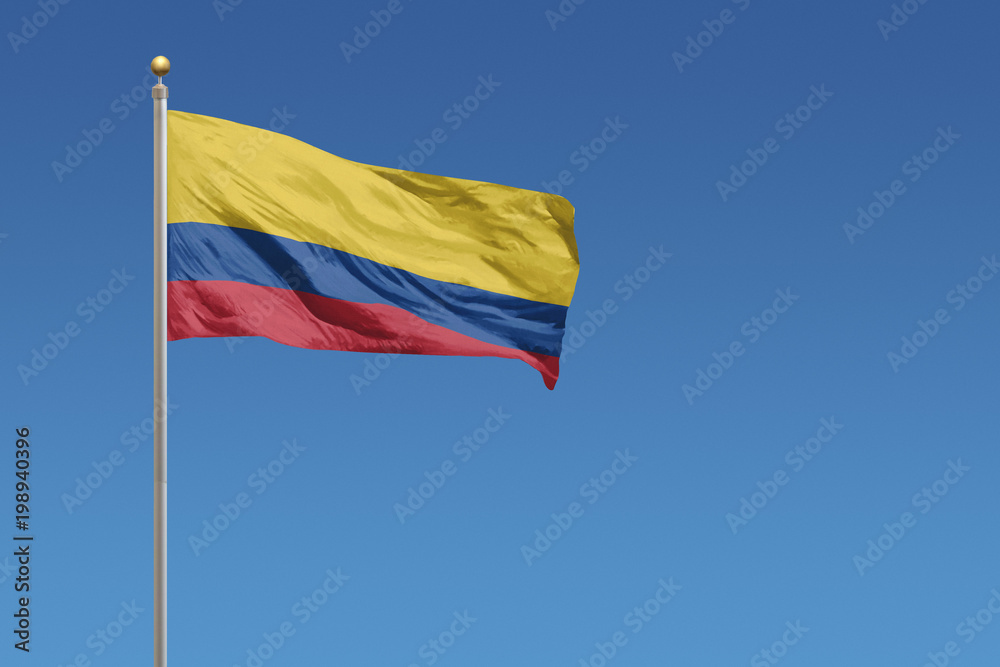 Flag of Columbia in front of a clear blue sky Flag of Columbia in front of a clear blue sky