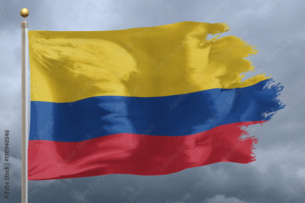 Naklejka premium Columbia Flag with torn edges in front of a stormy sky