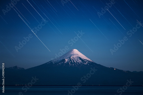 Volcano of Osorno and starry sky with trails. Chile photo