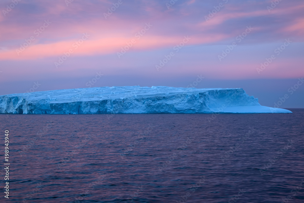 Southern Ocean Antarctica, pink sunset over iceberg