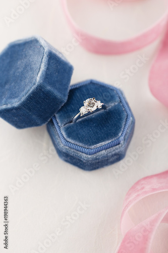 White golden wedding ring with diamonds in blue vintage velvet box
