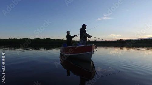 Men fishing at sunset
