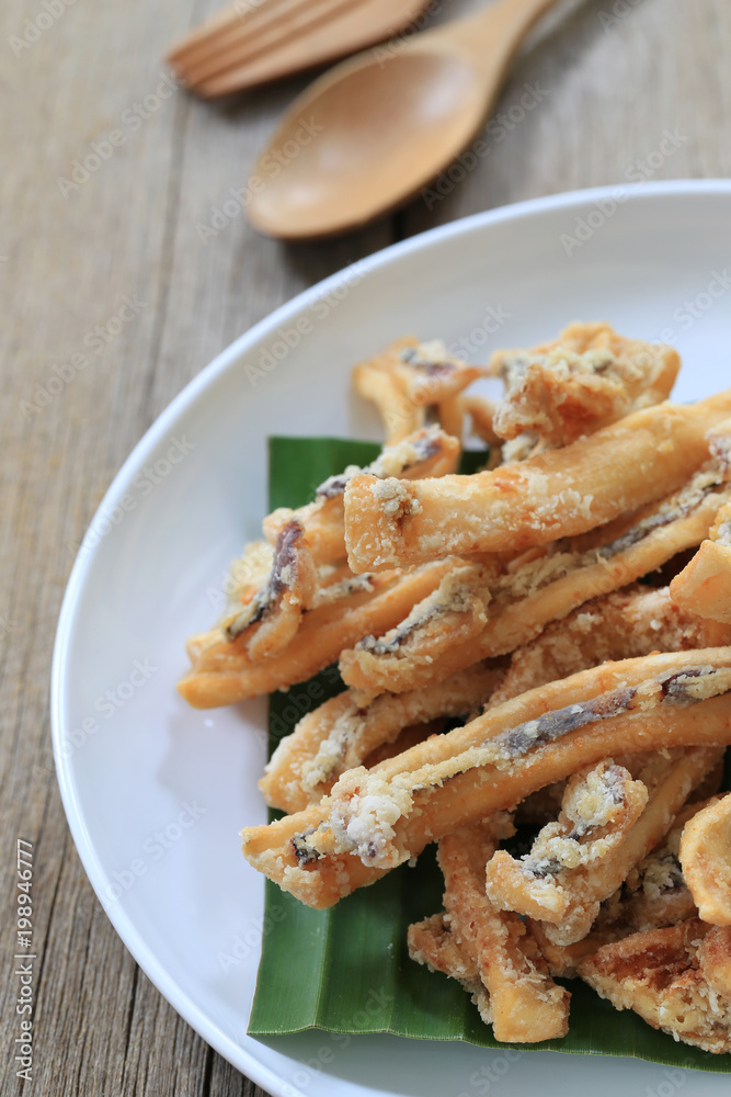 fried squid of Thai seafoods in the white dish on wood floor. fried squid of Thai seafoods in the white dish on wood floor.