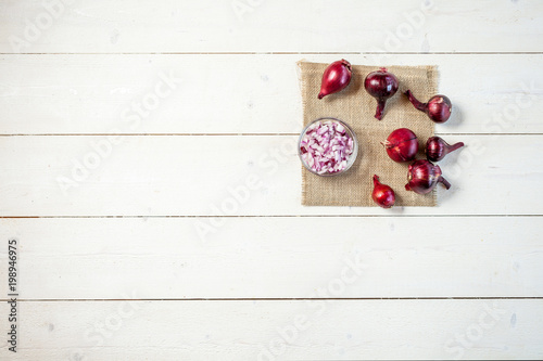 fresh onions on white a wooden table background with copy space for text. wallpaper for grocery shopping and cooking food concept. top view, flat lay