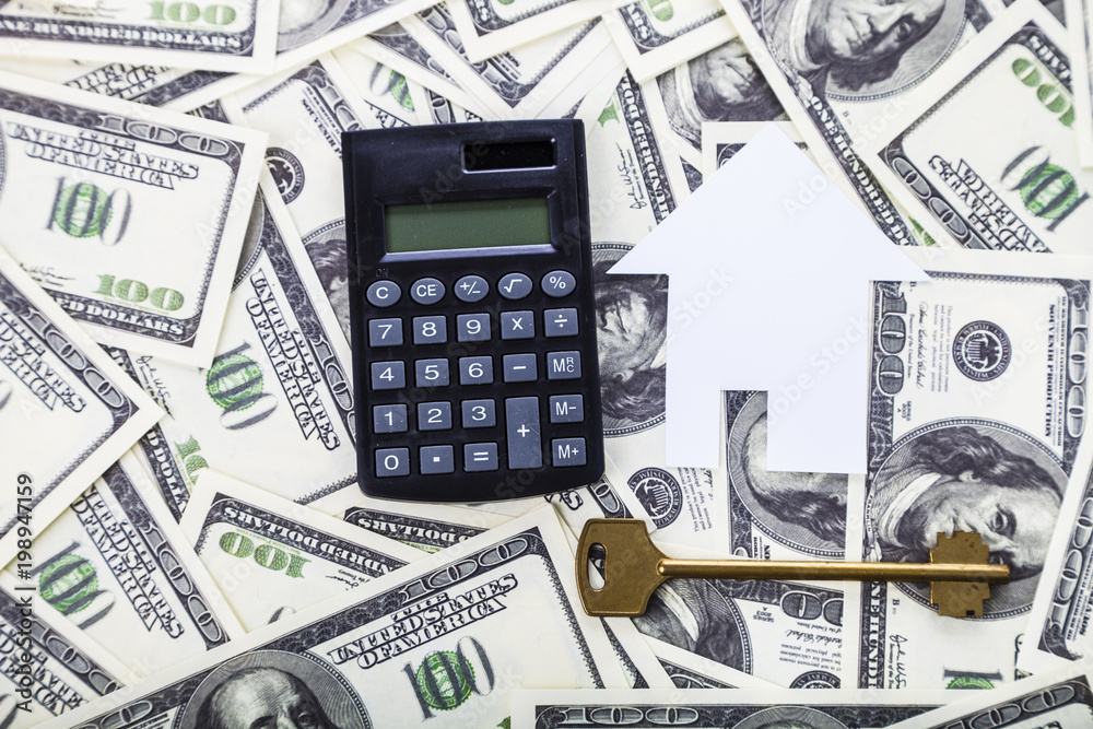 Cardboard house,calculator and key Cardboard house,calculator and key