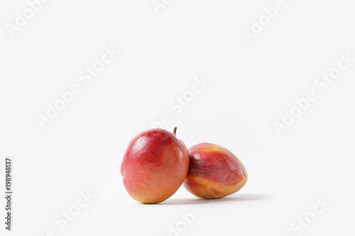 close up view of fresh mango fruits isolated on white