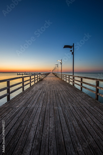 Wooden pier in Mechelinki. Small fishing village in Poland. Amazing Ssnrise at the beach