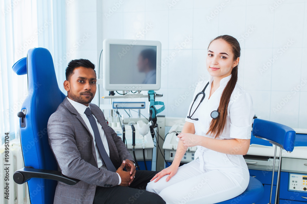 Fototapeta premium workplace. beautiful female doctor holds Asian patient's hand for encouragement and sympathy and touching her hand. The concept of partnership, trust and medical ethics. Bad news and support.