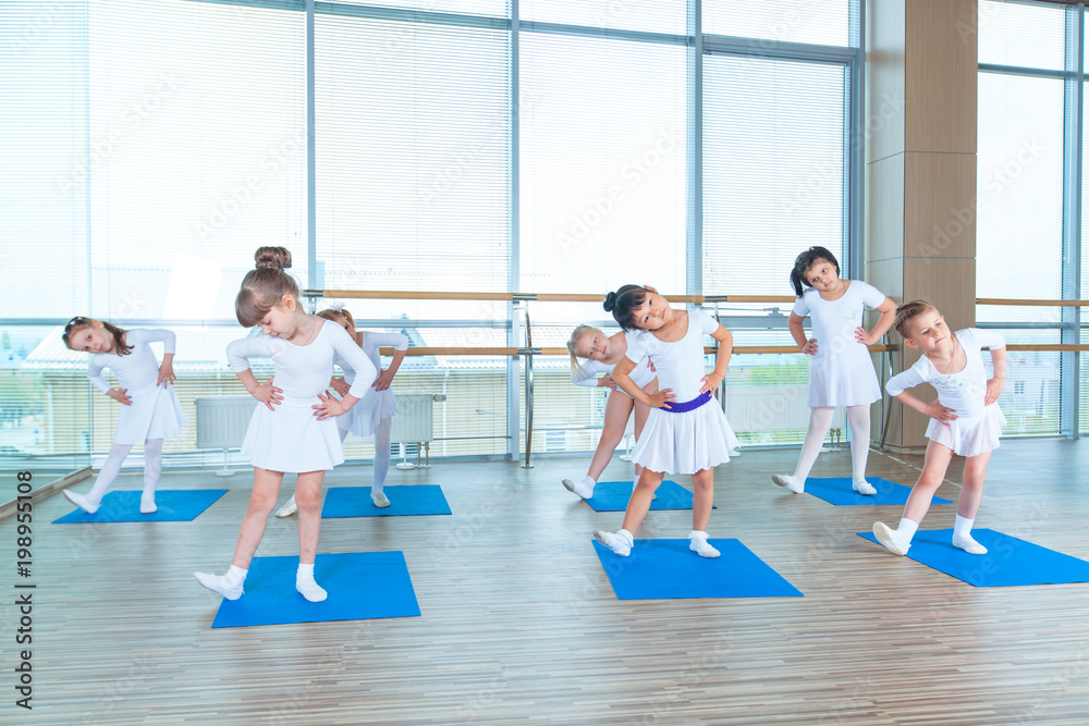 Girls doing gymnastic exercises or exercising in fitness class