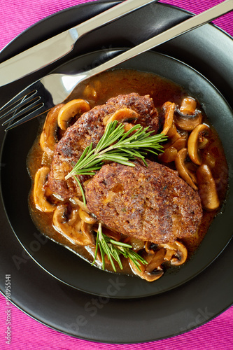 juicy salisbury steaks on black plate photo