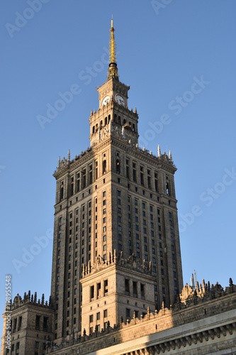 Palace of Culture and Science in sunset light with shadows of other highrises, Warsaw city, Poland, landmark from communist era.