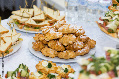 holiday buffet table served by different canape, sandwiches, snacks ready for eating in restaurant