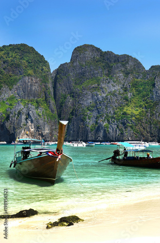 Longtail wooden Boat on crystal clear shallow water, Loh Dalum Beach , Ko Phi Phi , Thailand