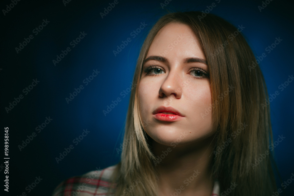 portrait smiling girl on blue background in studio portrait smiling girl on blue background in studio