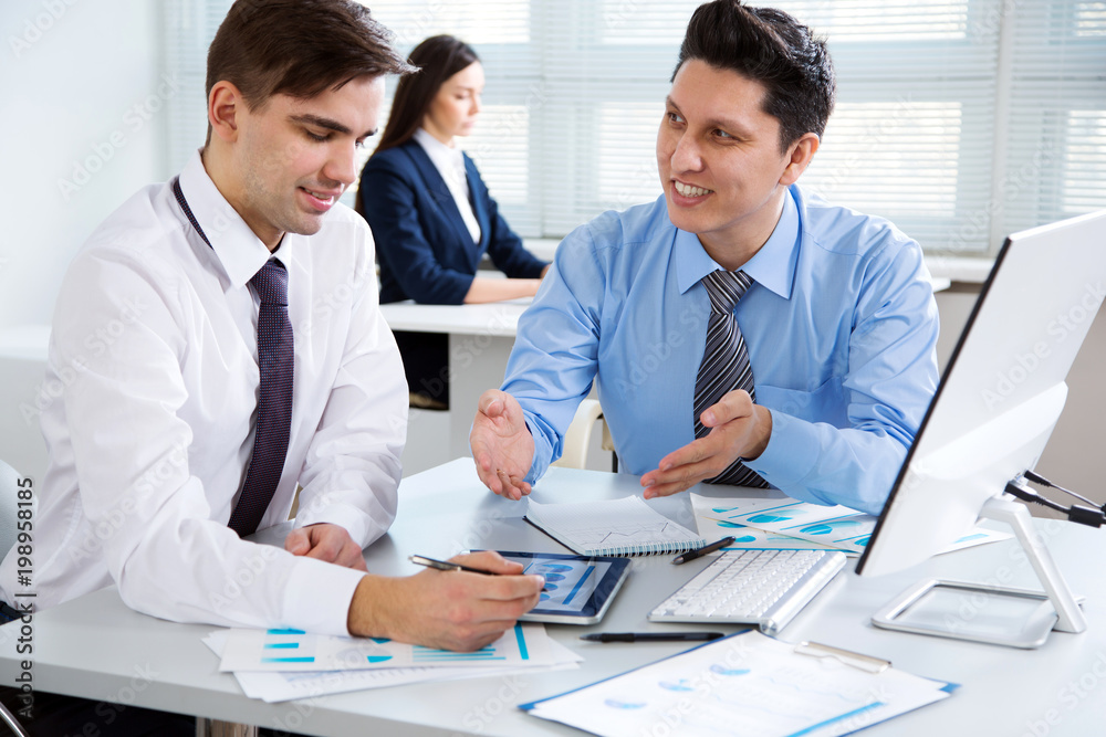 Businessmen working in an office Businessmen working in an office