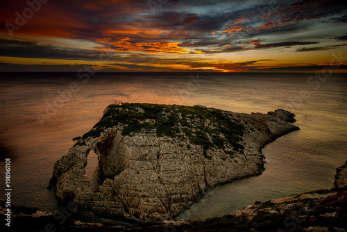 sunset over the rocks at korakonisi zakynthos photo