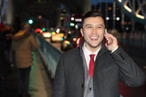 Elegant ethnic businessman calling by phone