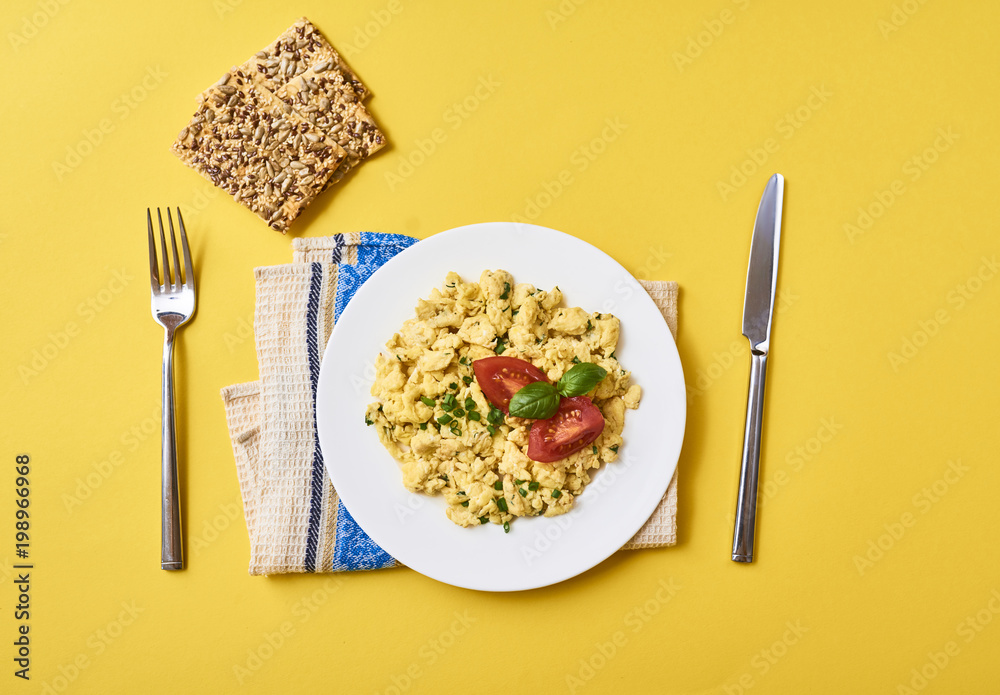 Scrambled eggs in plate on rustic background Scrambled eggs in plate on rustic background
