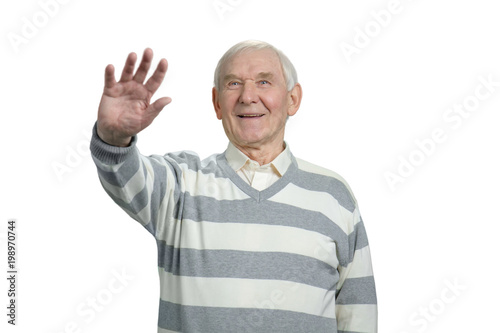 Old man greeting. Portrait of senior grandfather hailing with hand in white isolated background. © DenisProduction.com