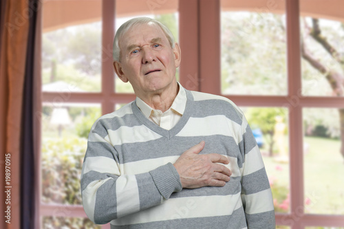 Old man having chest pain. Severe heartache, man suffering from heart attack.