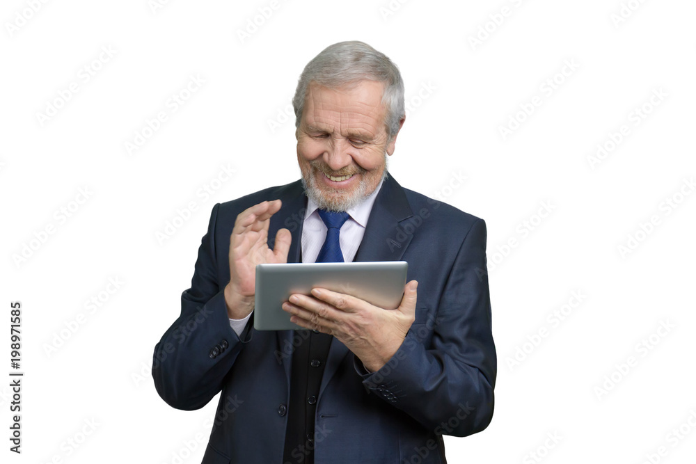 Cheerful smiling businessman with tablet device. Portrait of happy old senior man in business suit using portable computer device. White Isolated background. Cheerful smiling businessman with tablet device. Portrait of happy old senior man in business suit using portable computer device. White Isolated background.