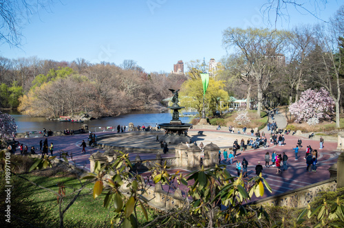 New York, NY / USA - April 2016: People in New York Central Park walking on the spring sunny day, view on Bethesda Terrace in early spring