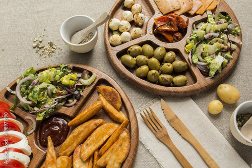 Vegetarian snacks on a wooden plate flatlay
