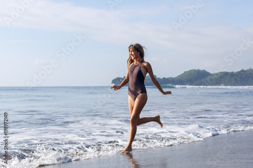 attractive slim girl running on beach near ocean © LIGHTFIELD STUDIOS