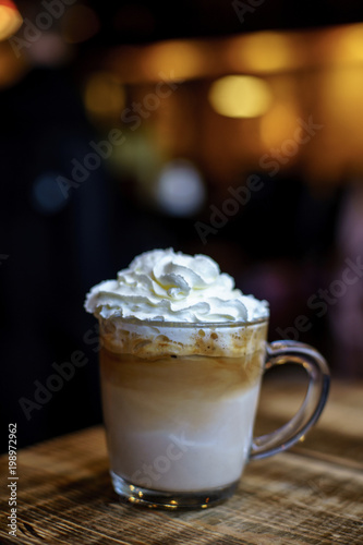 Ice Coffee Latte with Cream on blurry background