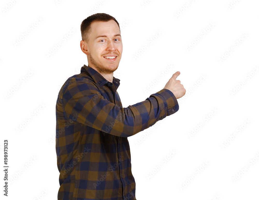 Young smiling bearded man in a checkered shirt showing direction with finger. Isolated on white background Young smiling bearded man in a checkered shirt showing direction with finger. Isolated on white background