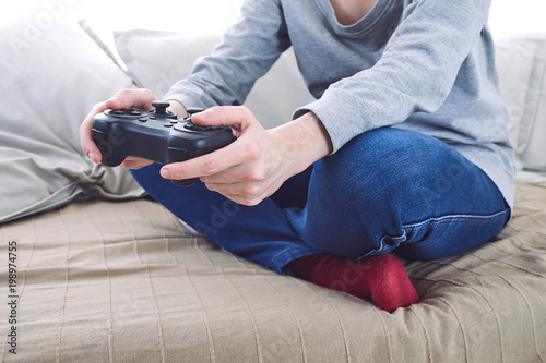 man holding a joystick controllers while playing a video games at home