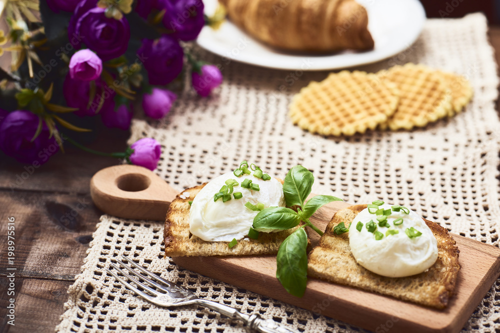 Tasty poached egg on toast over rustic background Tasty poached egg on toast over rustic background