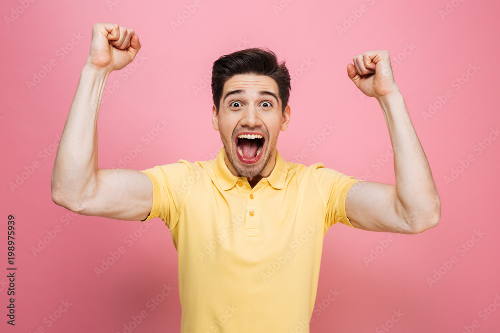 Portrait of a happy young man celebrating success Portrait of a happy young man celebrating success
