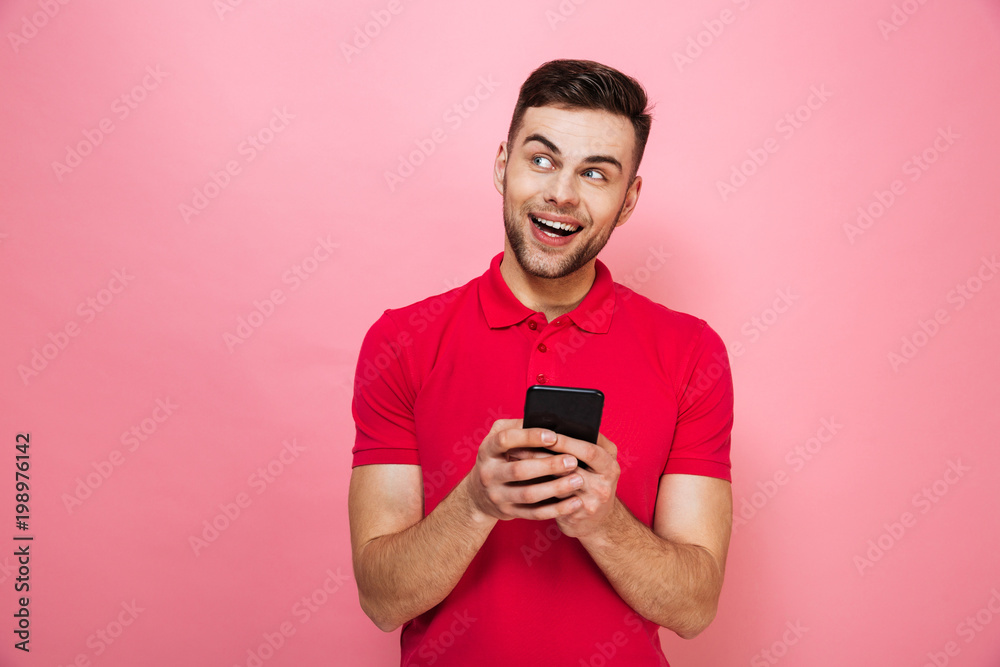 Portrait of a happy young man holding mobile phone Portrait of a happy young man holding mobile phone