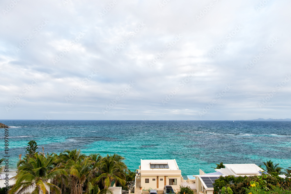 Villa on tropical sea beach in philipsburg, sint maarten. Beach vacation at Caribbean. Wanderlust, adventure and travel. View of blue sea on cloudy sky, nature Villa on tropical sea beach in philipsburg, sint maarten. Beach vacation at Caribbean. Wanderlust, adventure and travel. View of blue sea on cloudy sky, nature