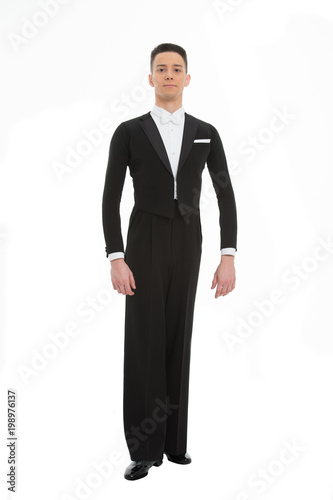Man in black suit full length isolated on white, dance. Ballroom dancer in tuxedo with bow tie, fashion. Dance, performance or entertainment concept. Mens fashion and style