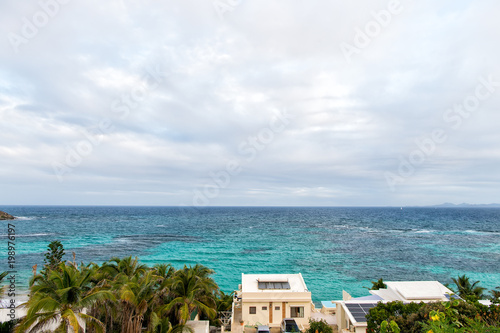 Villa on tropical sea beach in philipsburg, sint maarten. Beach vacation at Caribbean. Wanderlust, adventure and travel. View of blue sea on cloudy sky, nature