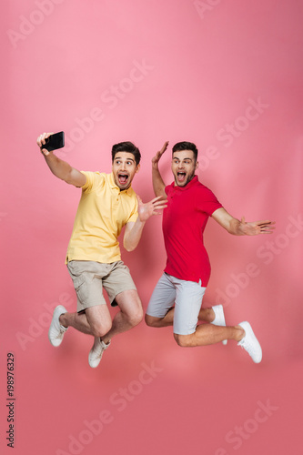 Full length portrait of an excited gay male couple